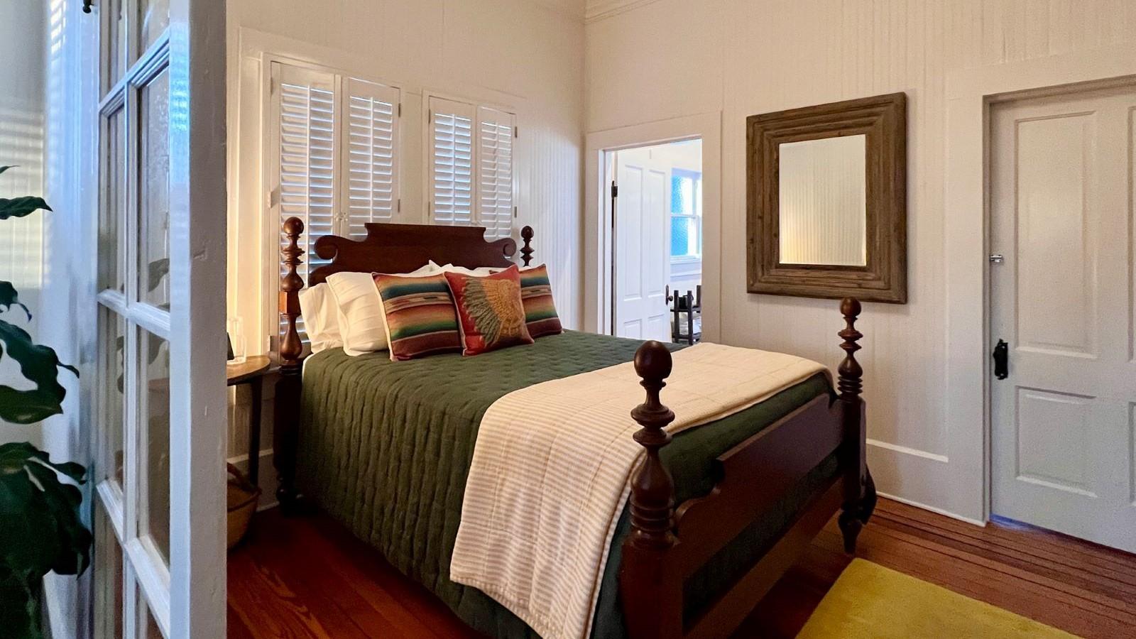 Bedroom with raised queen bed