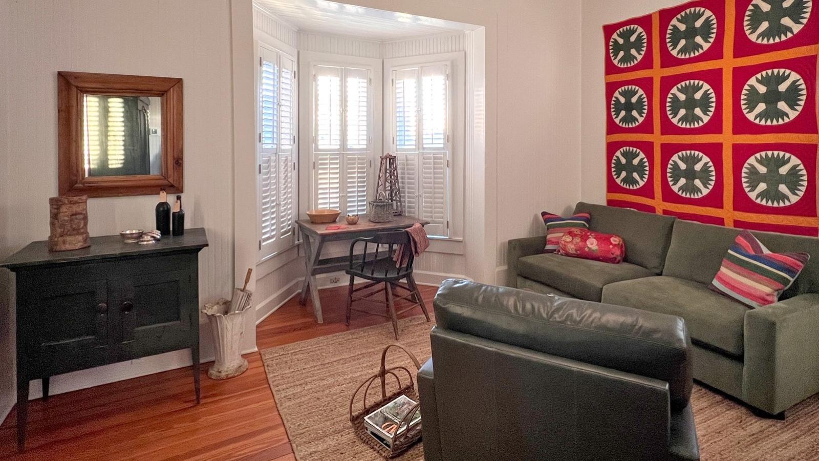 Living room with sofa, chair, and tables